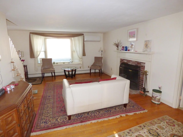 living room with wood-type flooring, an AC wall unit, a baseboard heating unit, and a fireplace