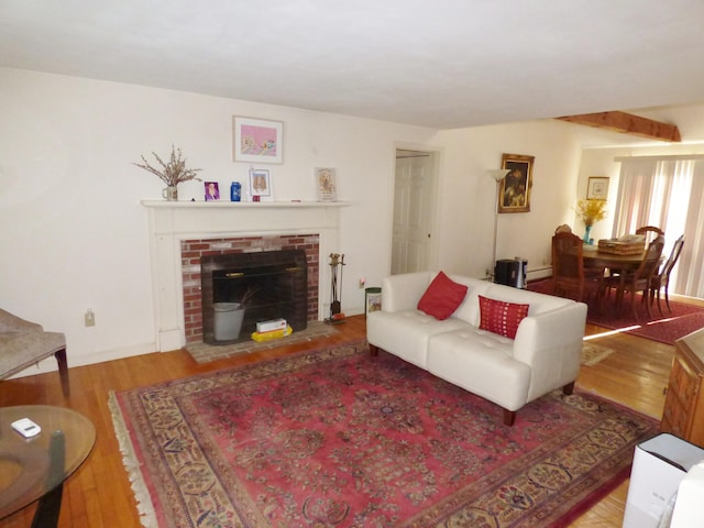 living room with a fireplace and light wood-type flooring