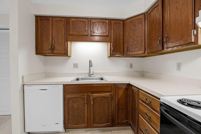 2 Englewood Dr Unit H-1, Harwich, MA 02645 - kitchen featuring white dishwasher, light countertops, brown cabinetry, and range with electric stovetop