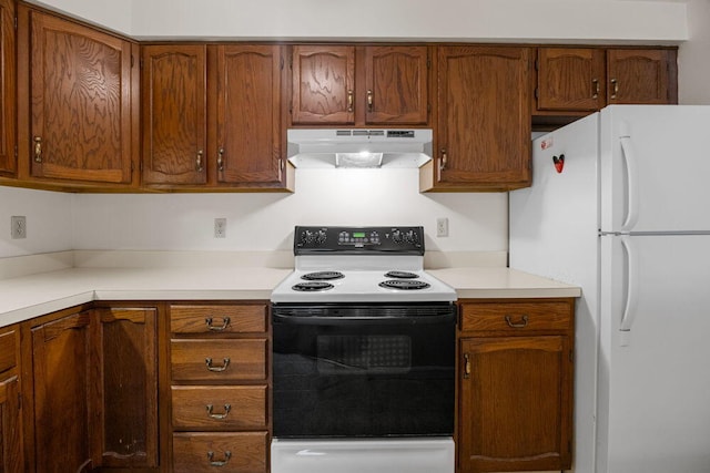 2 Englewood Dr Unit H-1, Harwich, MA 02645 - kitchen with freestanding refrigerator, electric range oven, under cabinet range hood, and light countertops
