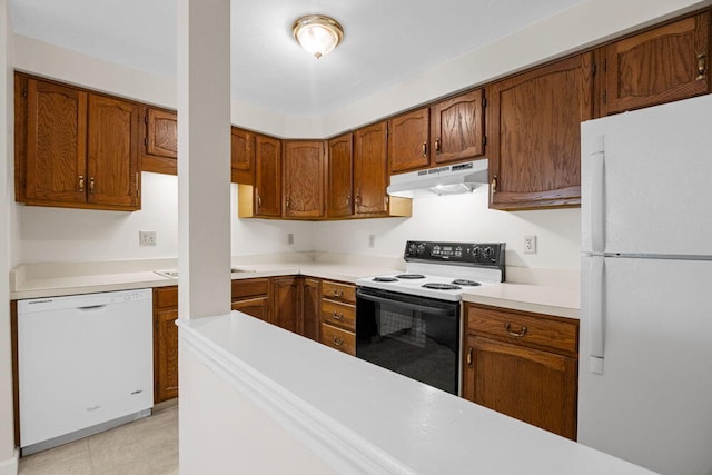 2 Englewood Dr Unit H-1, Harwich, MA 02645 - kitchen with white appliances, under cabinet range hood, and brown cabinets