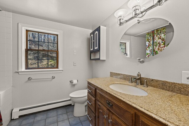 bathroom featuring a shower, toilet, a baseboard heating unit, vanity, and tile patterned floors