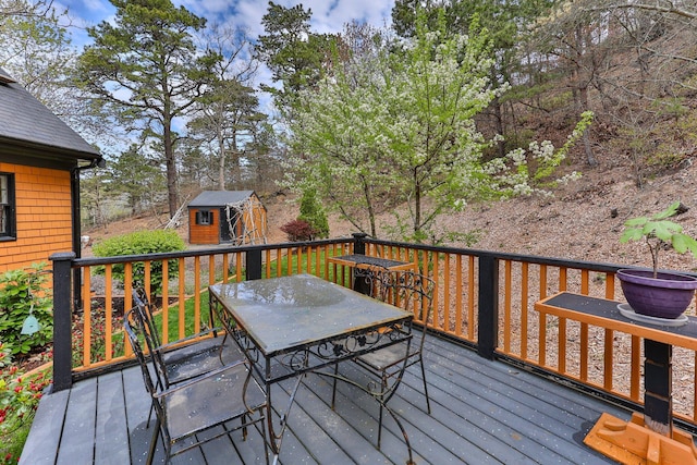 wooden terrace featuring a storage unit