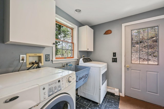 clothes washing area with a baseboard radiator, washer and clothes dryer, dark tile patterned floors, cabinets, and sink