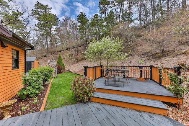 wooden terrace with a yard