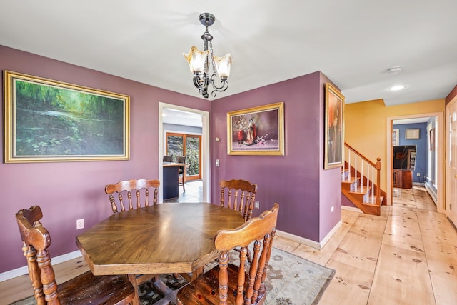 dining room featuring light hardwood / wood-style flooring and an inviting chandelier