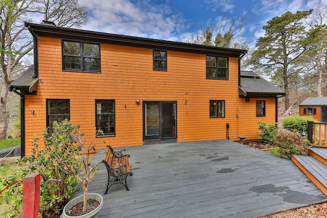 rear view of property featuring a wooden deck