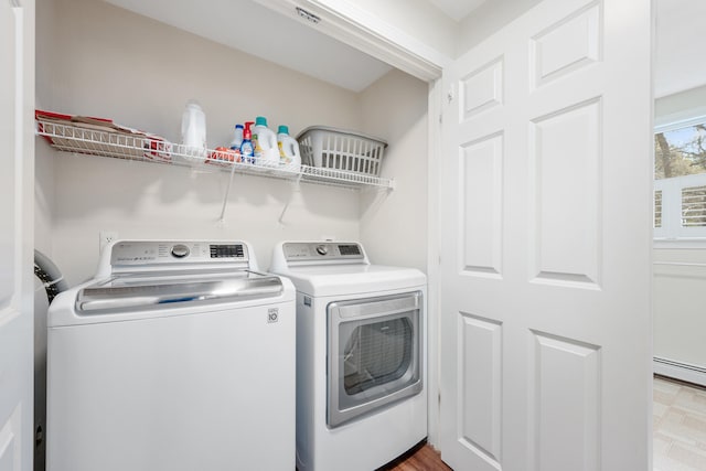 washroom with separate washer and dryer, laundry area, and a baseboard radiator
