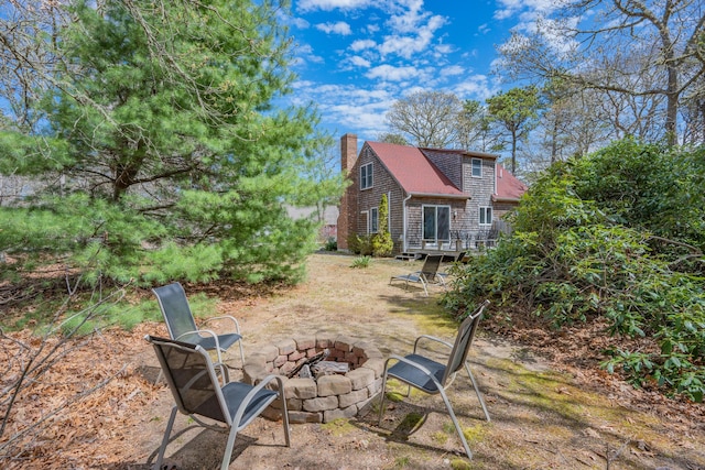 view of yard featuring an outdoor fire pit and a wooden deck