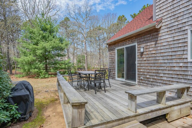 wooden deck featuring outdoor dining area