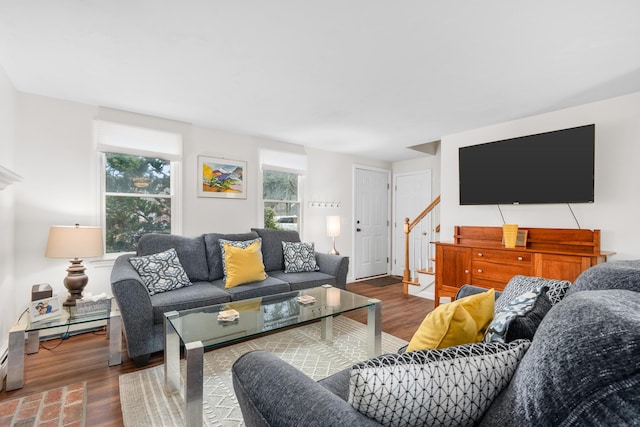 living area featuring stairs and wood finished floors