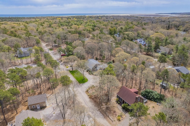 drone / aerial view with a wooded view