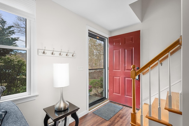 foyer entrance with a wealth of natural light, stairway, and wood finished floors