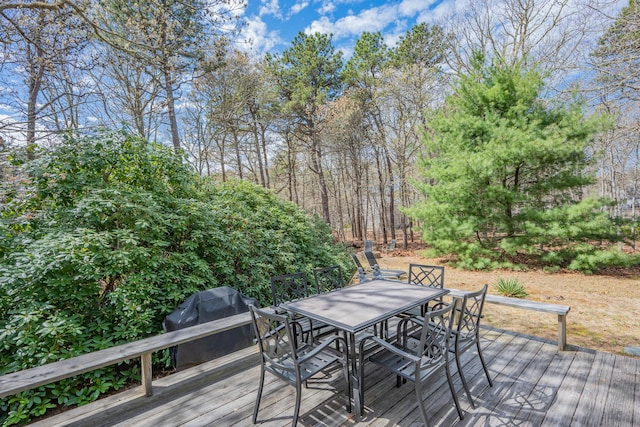 wooden terrace featuring outdoor dining area