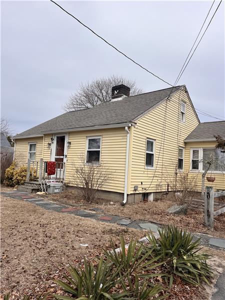 16 Edwards Ave, Dennis Port, MA 02639 - view of front of home with a chimney and roof with shingles