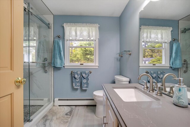 bathroom featuring a baseboard radiator, a shower stall, toilet, and healthy amount of natural light