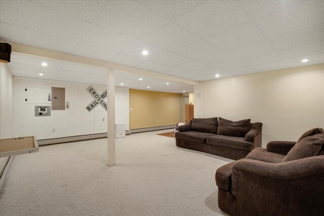 living room featuring a baseboard heating unit, carpet, electric panel, recessed lighting, and baseboards