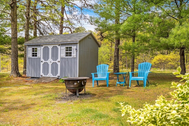 view of shed with an outdoor fire pit