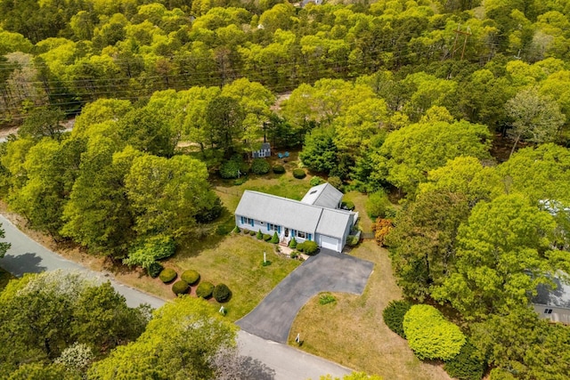 aerial view of property and surrounding area with a heavily wooded area