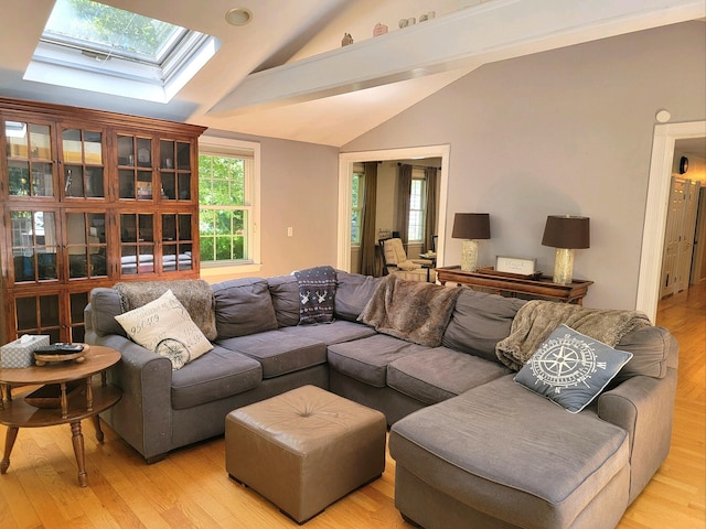 13 Quail Hollow Cir, Sandwich, MA 02563 - living room with lofted ceiling, a skylight, and light wood-style flooring
