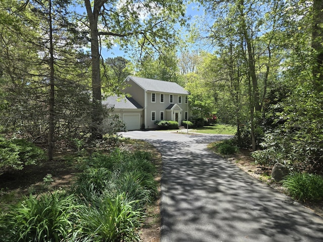 13 Quail Hollow Cir, Sandwich, MA 02563 - colonial-style house featuring asphalt driveway, a garage, and a shingled roof