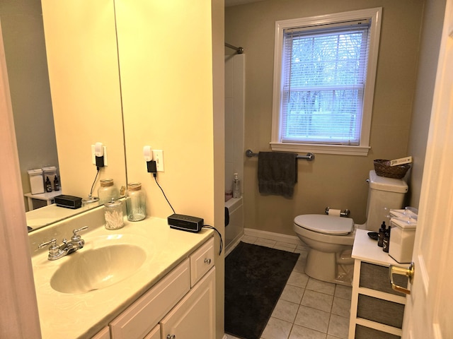 full bathroom featuring washtub / shower combination, baseboards, toilet, tile patterned floors, and vanity