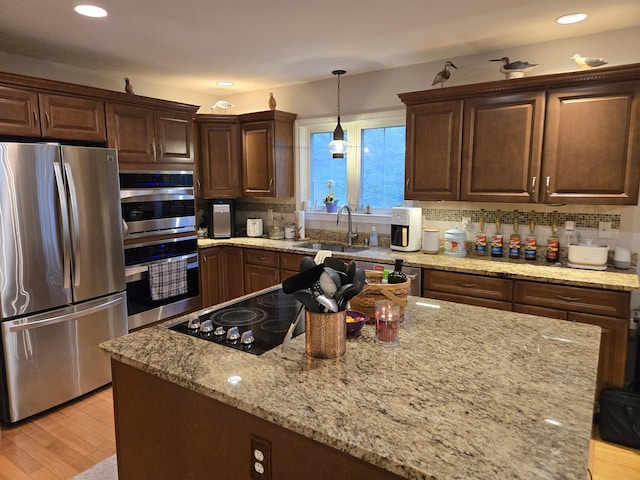13 Quail Hollow Cir, Sandwich, MA 02563 - kitchen with appliances with stainless steel finishes, a sink, backsplash, light stone countertops, and decorative light fixtures
