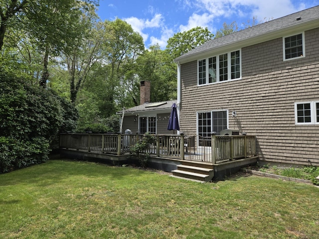 13 Quail Hollow Cir, Sandwich, MA 02563 - back of property with a yard, a wooden deck, and a chimney