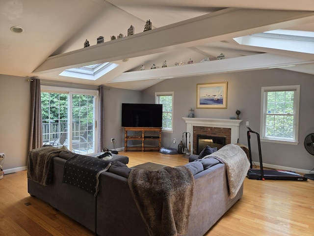 13 Quail Hollow Cir, Sandwich, MA 02563 - living room with a skylight, a fireplace, and light wood-style floors