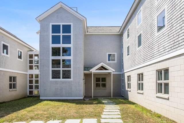 rear view of property with a lawn