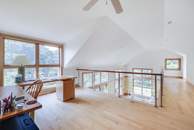 office with light wood-type flooring and lofted ceiling