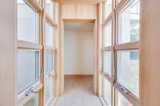 doorway to outside with light tile patterned floors