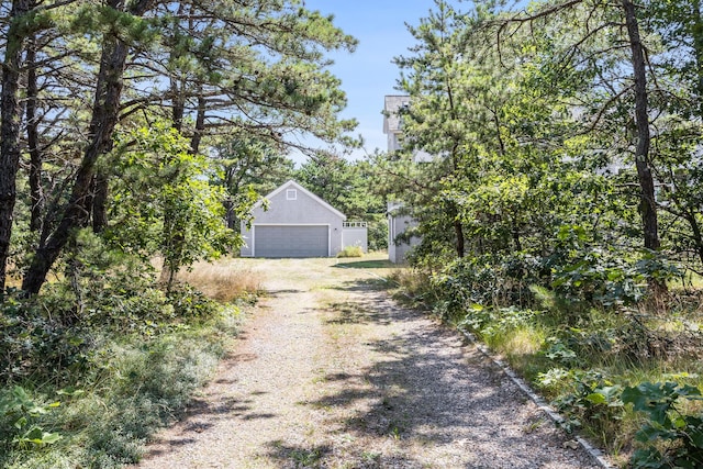 exterior space with a garage and an outbuilding