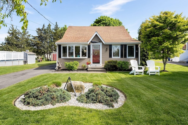 44 Buttermilk Way, Buzzards Bay, MA 02532 - bungalow featuring entry steps, a front yard, and a shingled roof