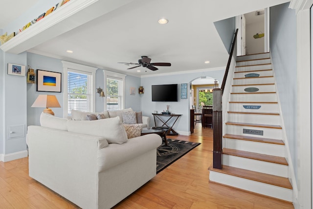 44 Buttermilk Way, Buzzards Bay, MA 02532 - living room with stairs, arched walkways, ornamental molding, a ceiling fan, and light wood-style flooring