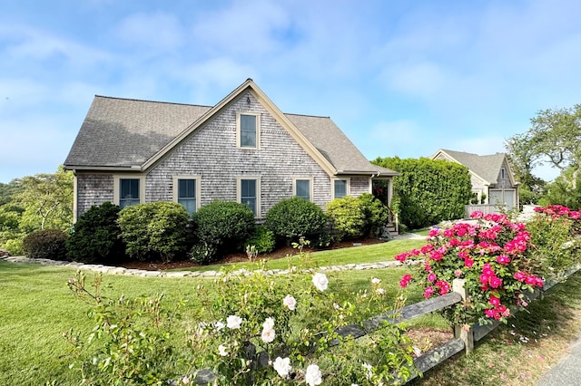 7 Squanto Dr, Chatham, MA 02633 - view of front of house with a front yard and roof with shingles
