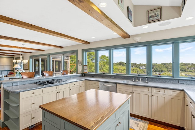 7 Squanto Dr, Chatham, MA 02633 - kitchen with stainless steel appliances, beamed ceiling, plenty of natural light, a peninsula, and wood finished floors