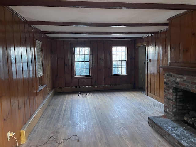 entrance foyer featuring a baseboard heating unit, a fireplace, light hardwood / wood-style floors, wooden walls, and beamed ceiling