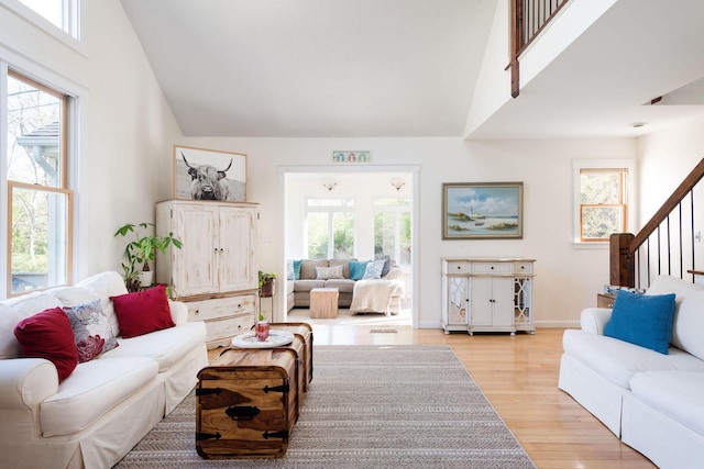 532 S Orleans Rd, Orleans, MA 02653 - living area with light wood finished floors, stairway, healthy amount of natural light, and vaulted ceiling