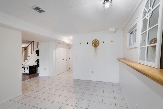 532 S Orleans Rd, Orleans, MA 02653 - empty room with stairway, light tile patterned floors, and a textured ceiling