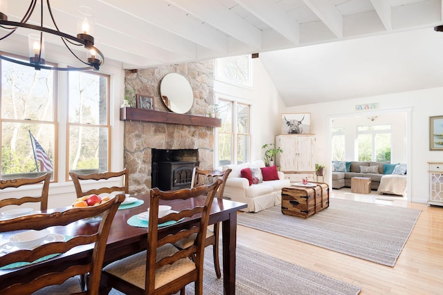 532 S Orleans Rd, Orleans, MA 02653 - dining space featuring wood finished floors, a chandelier, and a stone fireplace