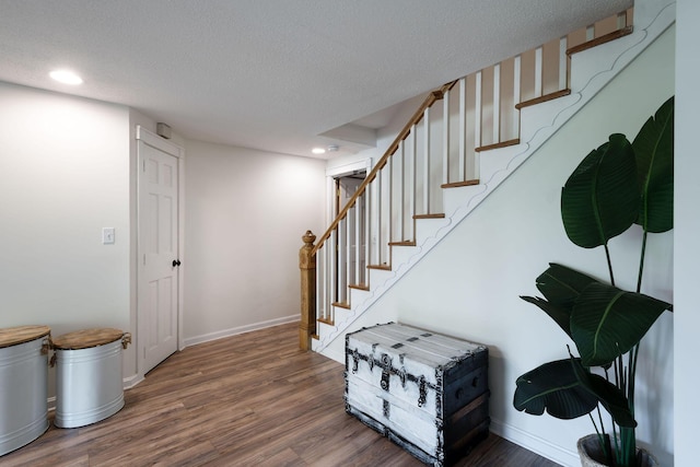 532 S Orleans Rd, Orleans, MA 02653 - staircase with wood finished floors, a textured ceiling, and recessed lighting