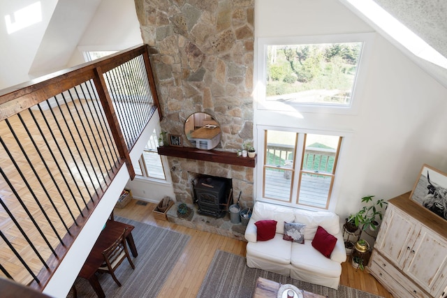 532 S Orleans Rd, Orleans, MA 02653 - living area featuring wood-type flooring, a wood stove, a skylight, and high vaulted ceiling