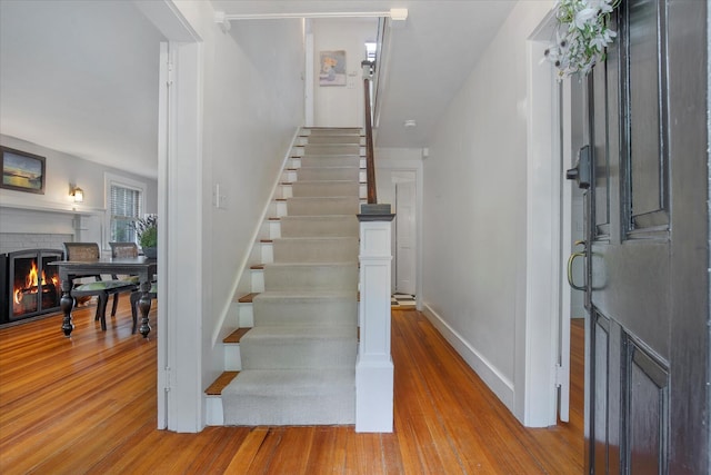 117 Parker Rd, Osterville, MA 02655 - stairs with wood finished floors and a brick fireplace