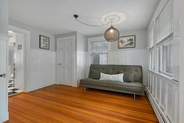 117 Parker Rd, Osterville, MA 02655 - sitting room with a decorative wall, light wood-style flooring, wainscoting, and a baseboard heating unit