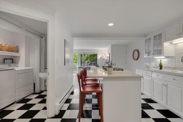 117 Parker Rd, Osterville, MA 02655 - kitchen featuring separate washer and dryer, baseboard heating, light floors, stainless steel gas stovetop, and ornamental molding
