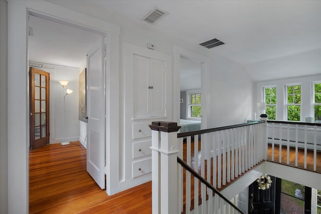 117 Parker Rd, Osterville, MA 02655 - corridor featuring an upstairs landing, wood finished floors, vaulted ceiling, a baseboard radiator, and baseboards