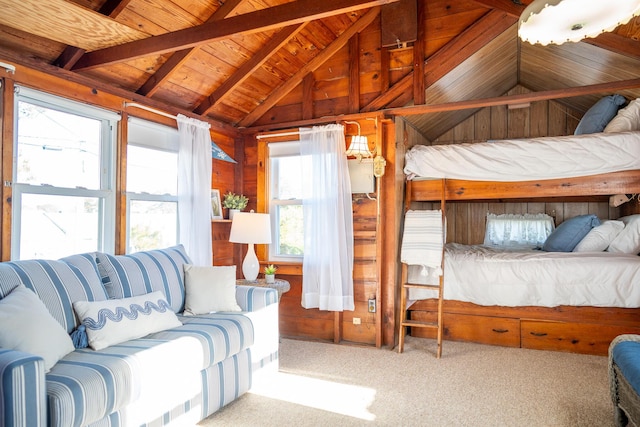 carpeted bedroom with wooden ceiling, lofted ceiling with beams, and wooden walls