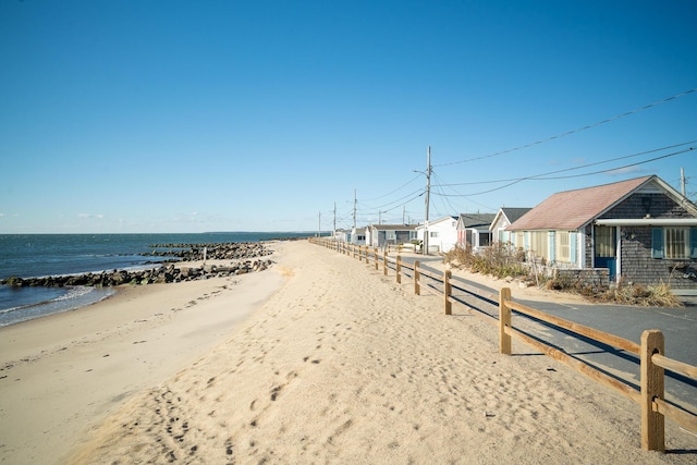 view of road featuring a beach view and a water view