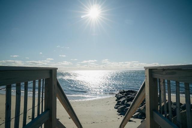 view of home's community featuring a water view and a view of the beach